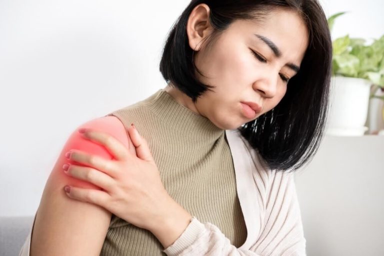 An Asian Woman Experiencing Pain And Discomfort On Her Left Shoulder That Was Caused By A Rotator Cuff Tear