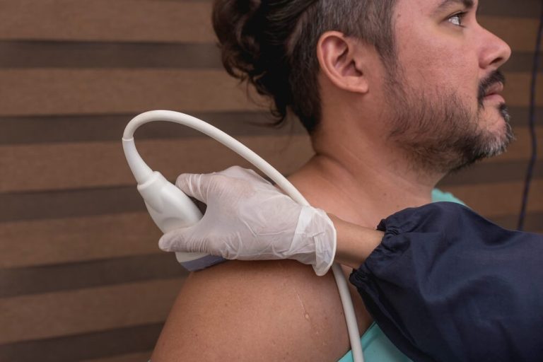 A Half Naked Man Being Diagnose For Rotator Cuff Tears With An Equipment Being Used During The Imaging Test