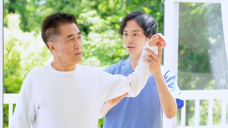 A Physiotherapist Helping An Elderly Man With Mobility To Treat Rotator Cuff Tears Without Surgery